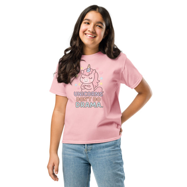 Girls' unicorn light pink t-shirt featuring "Unicorns don't do drama" wearing by a model